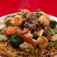 Hong Kong Style Chow Mein · Crispy pan cried noodle with chicken bee shrimp and veggies topped with a light garlic sauce.