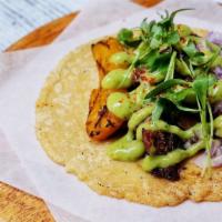 Al Pastor Taco · Marinated pork loin, red onion, grilled pineapple, micro cilantro, and avocado salsa verde.