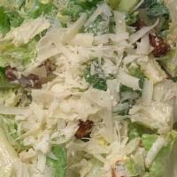 Caesar Salad · Crisp romaine lettuce, Parmesan cheese and homemade croutons tossed in our Caesar dressing.