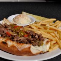 Philly Cheese Steak · Rib-eye beef topped with grilled onions, peppers, mushrooms and melted provolone cheese on a...