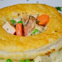 Miltons Pot Pie · Oven roasted turkey breast, in a stew of carrots, peas, onions, potatoes, and mushrooms topp...