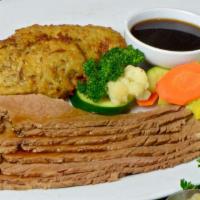 Brisket Dinner · Tender slow cooked beef brisket served with traditional potato pan cakes and fresh steamed v...