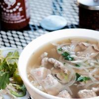 Phở Đặc Biệt · Combination beef noodle soup with sliced steak, brisket, flank, tendon, tripe and meatballs.