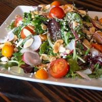 House Salad · Mixed greens, goat cheese, marinated cherry tomato, almonds, radish, and herb vinaigrette.