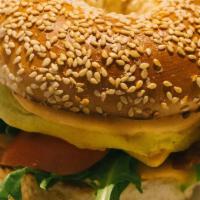 Brekkie Sando · 2 cage-free scrambled eggs, mild cheddar cheese, arugula and tomatoes on a sesame seed bagel...