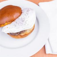Classic Fried Egg Sandwich · Two eggs and cheddar cheese on a brioche bun with choice of bacon or sausage. Served with on...
