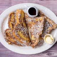 Cinnamon French Toast · Two Full Slices of Thick Egg Bread Dipped in Scrambled Eggs and Cinnamon.