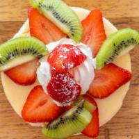 New York Cheesecake · New York style cheesecake comes with Strawberry sauce, whipped cream, powder sugar and a sco...