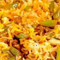 Lubia Polo With Meat · Basmati rice with green beans, tomato paste and fried ground beef.