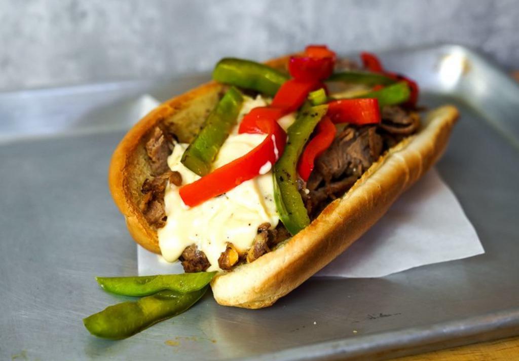 Grilled Pepper Cheesesteak · 8” Philly cheesesteak loaded with grilled steak, melted cheese, and grilled bell peppers on a toasted hoagie roll