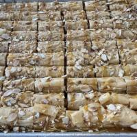 Almond Caramel Baklava · Thin layers of fillo dough folded and filled with crushed premium almonds and cashews baked ...
