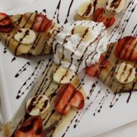 Chocolate Dosa · Dosa filled with chocolate, topped with strawberries, bananas, whipped cream and chocolate s...