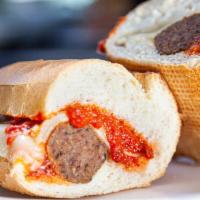 Meatballs With Cheese Sandwich · Homemade meatballs with melted mozzarella and marinara sauce on baguette.
