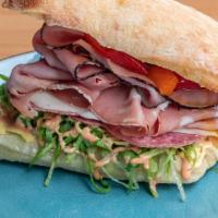 Muffuletta Sandwich · Ciabatta bread, mortadella, Black Forest ham, Genoa salami, provolone cheese, lettuce, bell ...