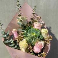 Fairytale Fantasy · Includes pink and white roses, wax, cabbage, and eucalyptus wrapped in pink paper.