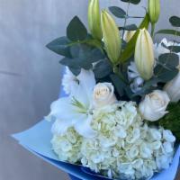 In Harmony · Includes white lilies, roses, hydrangeas and dianthus wrapped in premium paper.