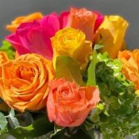 Floral Fantasy · Yellow, pink, and peach roses with hydrangeas hand arranged in a glass vase.