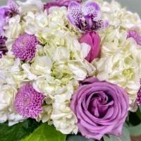 A Touch Of Purple · Includes hydrangeas, roses, chrysanthemum, tulips, and greenery arranged in a square glass v...