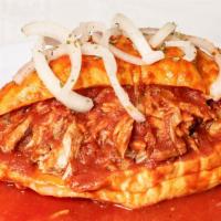 Torta Ahogada · Carnitas, refried beans,  covered with a tomato mild or hot sauce, and onions with lemon. Th...