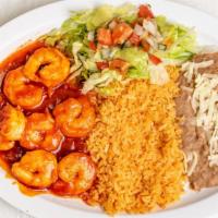 Camarones A La Diabla · Spicy deviled shrimp cooked in a red hot sauce served with rice, beans, and salad.