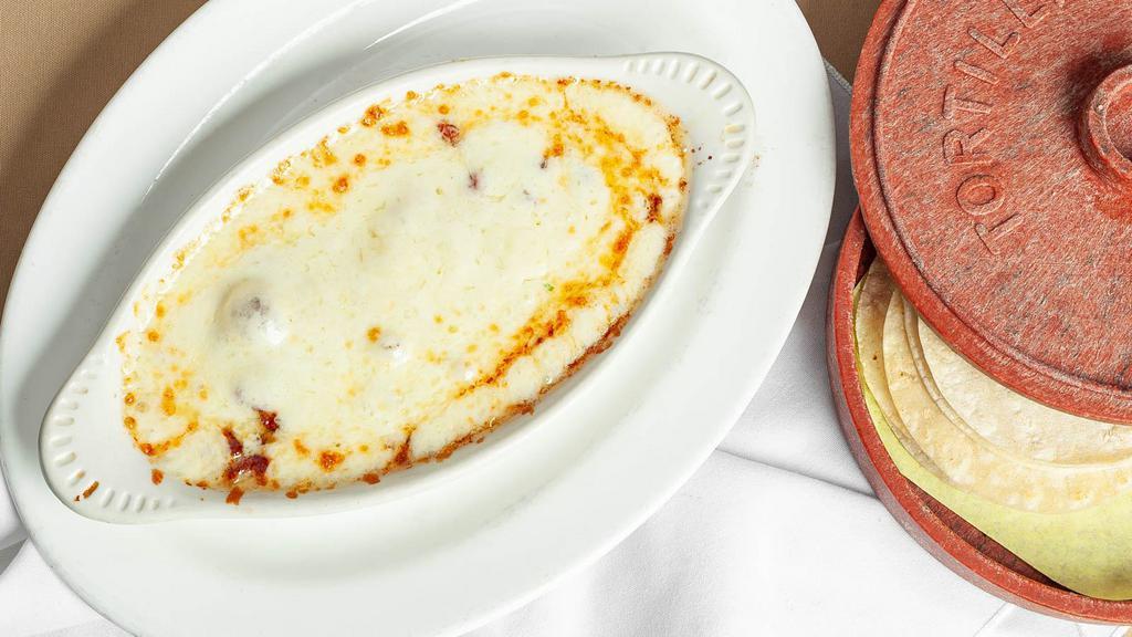 Choriqueso · Melted cheese with mexican sausage. Served with tortillas.