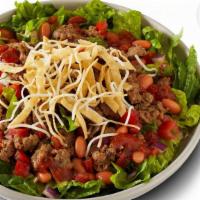 Impossible™ Taco Salad · IMPOSSIBLE™ Meat Made From Plants served on fresh romaine lettuce and pinto beans, topped wi...