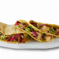 Street Style Chicken Tacos · Grilled adobo chicken in soft corn tortillas topped with hand-crafted guac, salsa verde, pic...