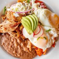 Chilaquiles · Red or green chilaquiles served with sour cream, queso fresco,  red onion, spicy salsa, 2 eg...