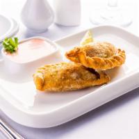 Empanadas De Pollo (2 Pcs.) · Crispy pastry dough filled with a delicious combination of chicken and shrimp mixed with Moz...