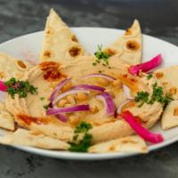 Hummus · A delicious middle eastern blend of garbanzo beans, tahini, fresh garlic, and house herbs.