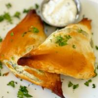 Spinach Pie (Spanakopita) · Layers of filo dough stuffed with spinach, feta cheese, golden brown (2 pcs).