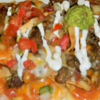 Nachos · Your choice of meat (grilled steak, grilled chicken, or chile Verde) served over nacho torti...