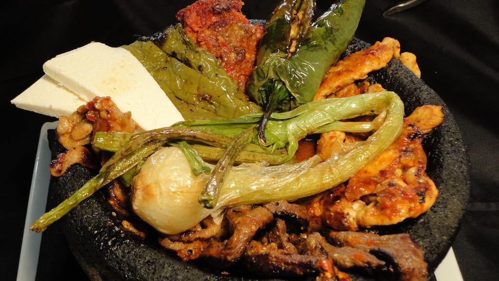 Fp Molcajete · A traditional mix of grilled steak, grilled chicken, chorizo, shrimp, Mexican queso fresco and cactus simmered in a mild red sauce.
