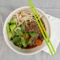 Kuay Teow Reua (Thai-Style Pho) · Vegan. Spicy rice noodle soup, veggie beef, bok choy, carrots, bean sprout, cilantro, scalli...