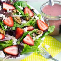 Summer Field Salad · Fresh strawberries, Feta cheese, walnuts over a bed of mixed greens.