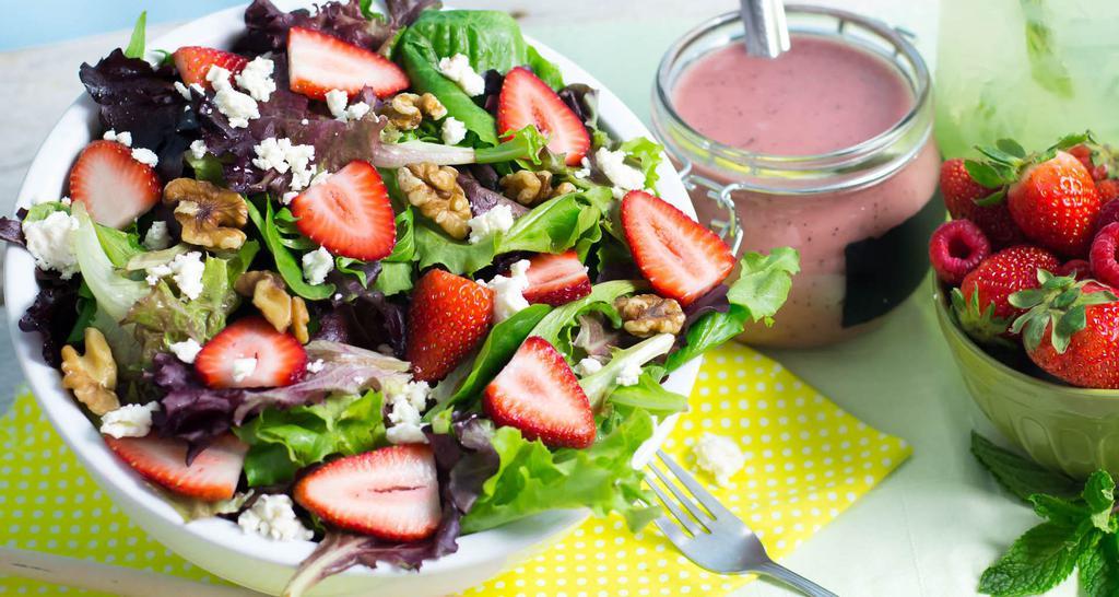 Summer Field Salad · Fresh strawberries, Feta cheese, walnuts over a bed of mixed greens.
