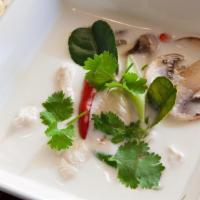 Tom Kha Soup · Galanga-kaffir lime broth, coconut milk, fresh mushrooms and bird-eye chili. Spicy.