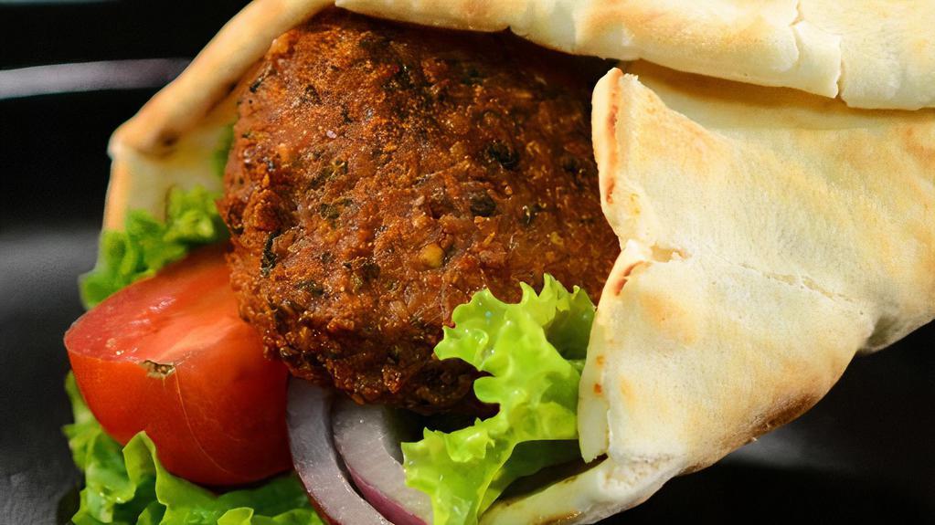 Falafel Sandwich · Served with hummus, lettuce, tomato, and red onion wrapped in pita bread.