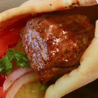 Beef Kebab Sandwich · Served with tomatoes, onions, parsley, pickles, and Antonio's spread wrapped in pita bread.