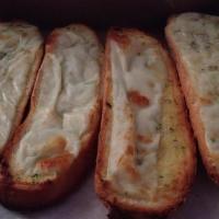 Cheesy Garlic Bread · Hot buttered garlic bread sticks topped with mozzarella.