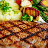 New York Steak (12 Oz) · New York Steak with a side of Mashed
Potatoes, Grilled Onions & Vegetables