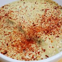 Hummus 8 Oz · Garbanzo beans, fresh garlic and tahini.  Comes with 2 pita