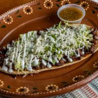 Huarache · Large fried thick corn tortilla, choice of meat, refried beans, lettuce, cheese, sour cream,...