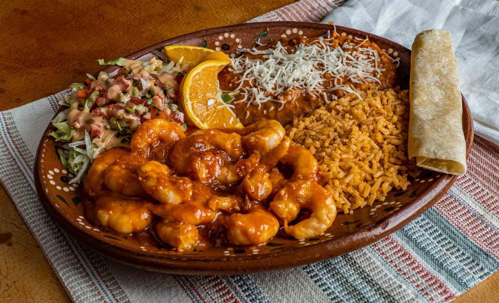 Camarones A La Diabla · Spicy shrimp plate with rice and beans.