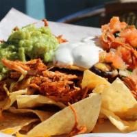 Benny’S Nachos · Generous portion of tortilla chips topped with jack cheese, pico de gallo, sour cream, guaca...
