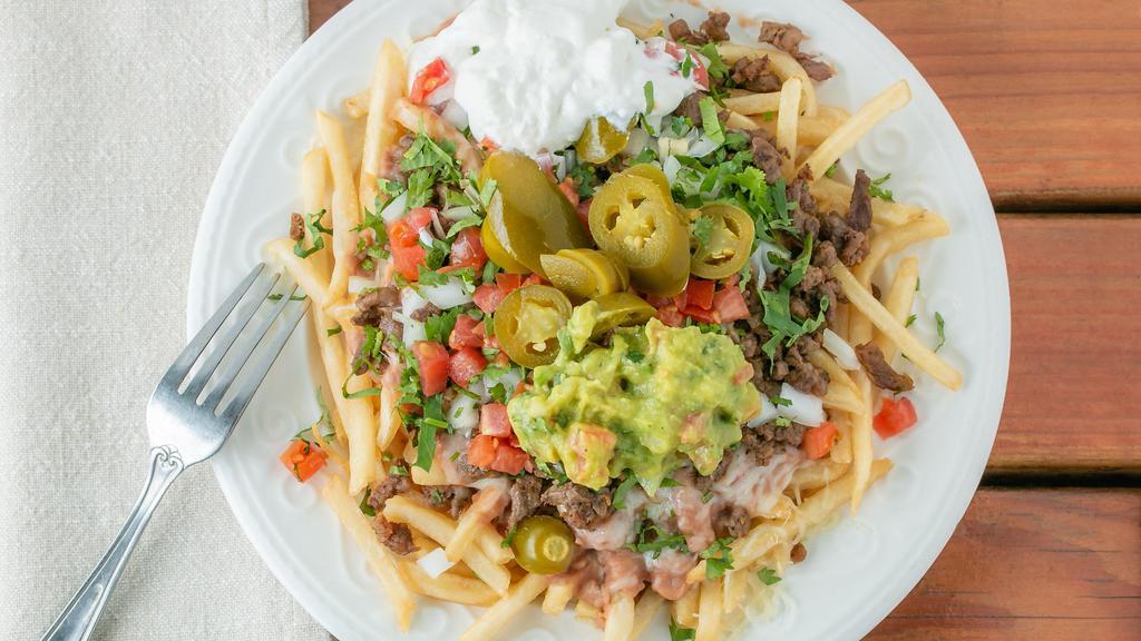 Carne Asada Fries · Comes with carne asada, guacamole, sourcream, cheese, beans, onions, cilantro, tomatoes, jalapenos.