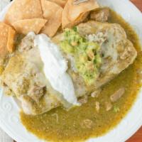Chile Verde Wet Burrito · Chile Verde Burrito Wet with chile verde sauce topped with chunks of pork meat on top. Comes...