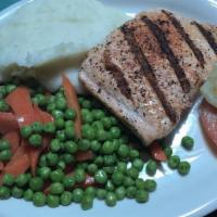 Blackened Salmon Dinner · Grilled salmon, Cajun spices, served with mashed potatoes, peas and carrots.