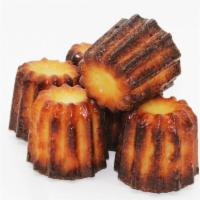 Caneles · French pastries with a soft and tender vanilla custard center and a thick caramelized crust.