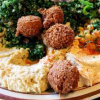 Humos Falafel · Humos plate served with three pieces of falafel on top.